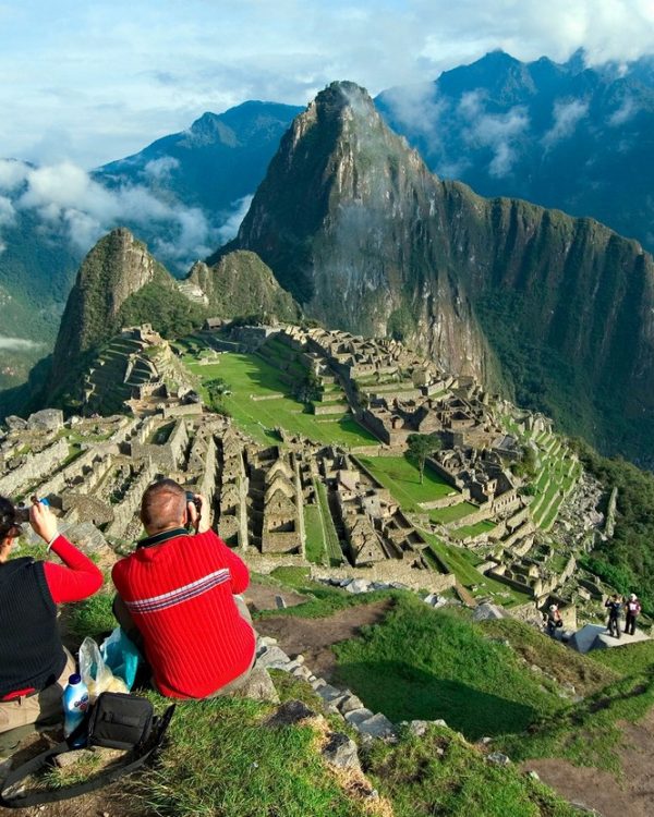 Hikers enjoy a sunrise view of Machu Picchu, the great Incan city in the Andes in Peru near the city of Cusco. MODEL RELEASED. Heinrik & Birgit Roye, Koln, Germany